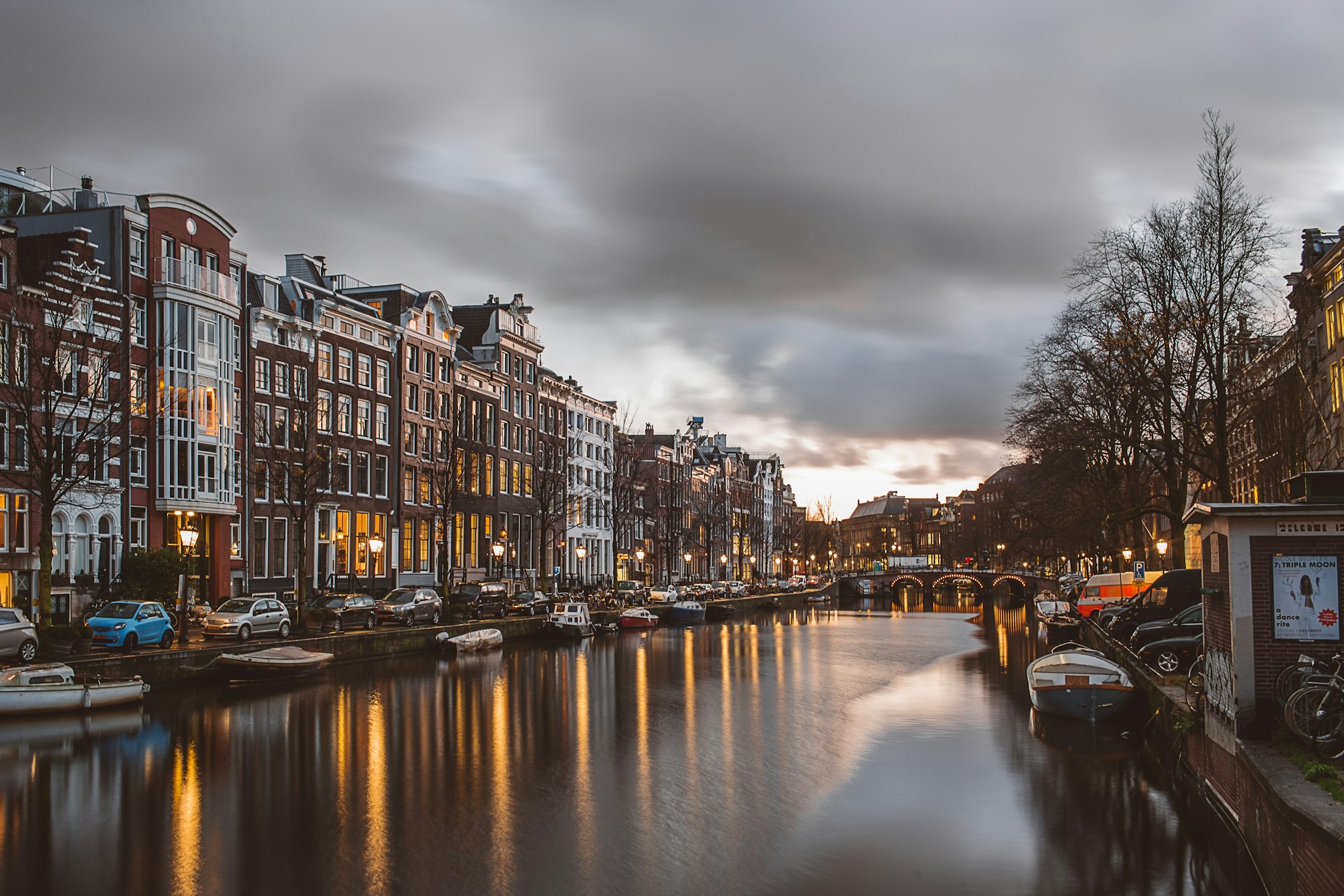 Amsterdam canals with traditional houses at sunset